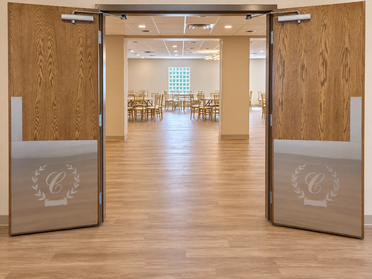 The doors to the hall standing open, round tables beyond them.